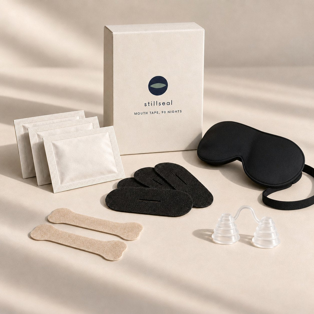 Everything in the Stillseal complete kit laid out: box, three packs of strips, nose strips, nose vents and the sleep mask